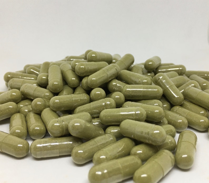 May include: A large pile of green capsules, likely a dietary supplement or herbal remedy.