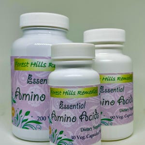 May include: Three white supplement bottles with white lids. The bottles feature labels with the text "Forest Hills Remedies Essential Amino Acids". The labels are light purple with floral designs. The bottles contain 30, 90, and 200 capsules.