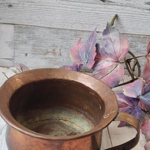May include: A set of three ceramic mugs with a speckled, matte finish. The mugs are in shades of cream, light grey, and dark grey. Each mug has a simple, minimalist design, ideal for coffee or tea.
