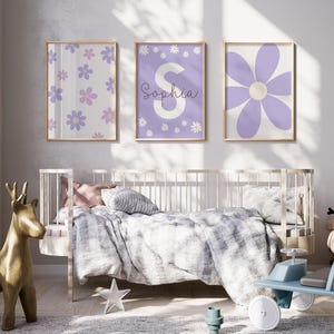 May include: Three framed prints with a purple and white floral design. The center print features the name "Sophia" in white lettering.