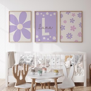 May include: Three framed prints with a purple and white floral design. The center print features the name "Luna" in a white font with a large white letter "L".