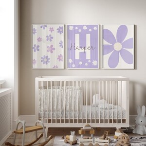 May include: Three purple and white floral nursery prints with the name "Harper" on one of the prints.
