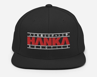 May include: Black baseball cap with a white embroidered logo that says "HANKA ROBOTICS" in red letters. The logo also includes the Japanese text "人工知能とロボット工学".