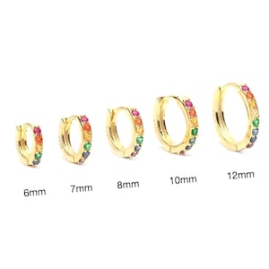 May include: Five gold hoop earrings with a rainbow of colourful gemstones set around the hoop. The hoops are available in sizes 6mm, 7mm, 8mm, 10mm, and 12mm.