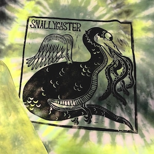 May include: Black and white graphic of a Snallygaster creature with wings and tentacles, printed on a tie-dye shirt. The shirt has a green and yellow spiral pattern.