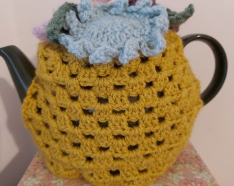 Handmade crochet tea cosy in mustard adorned with crochet flowers for a perfect housewarming gift, kitchen decor tea cozy, mothers day