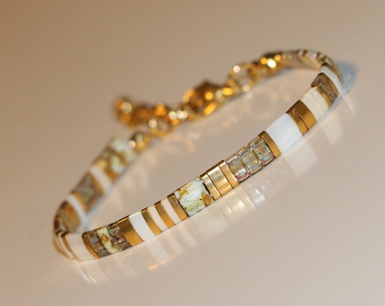 tila bracelet , random pattern of tile beads (square, half and quarter) in white, caramel, picasso yellow, transparant topaz and gold. classy, dainty bohemian style bracelet. Lightweight. stainless steel lobster clasp and extensionchain.