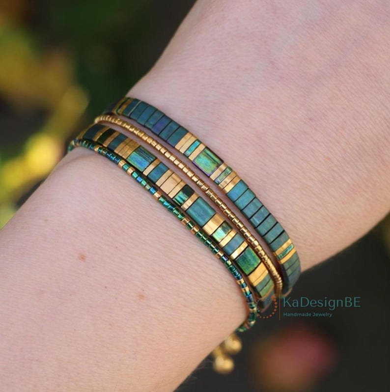 green gold bracelet stack on a wrist. Miyuki tila beads and delica beads in shades of green and 24kt gold. Minimalist and dainty bracelet set of four; two tila glass bead bracelets and 2 tiny delica bracelets. The tila's have a lobster clasp and extension chain. The delicas are custom size
