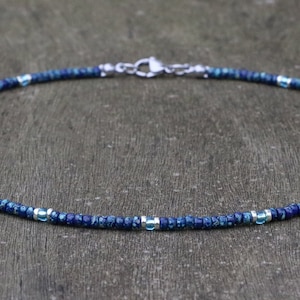 seed bead necklace in blue picasso miyuki glass beads and aqua transparant bead accents. silver spacer accents around the aqua beads. minimalist bohemian style choker necklace. boho summer festival vibes. good for layering with other necklaces