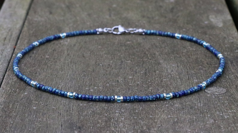 seed bead necklace in blue picasso miyuki glass beads and aqua transparant bead accents. silver spacer accents around the aqua beads. minimalist bohemian style choker necklace. boho summer festival vibes. good for layering with other necklaces