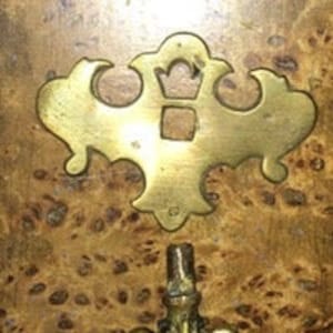 May include: Brass door hardware set with a decorative keyhole cover and a pull handle.