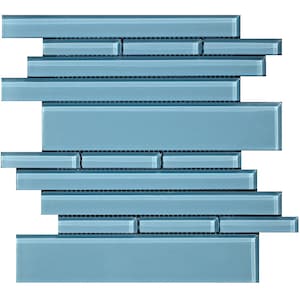 May include: A mosaic tile sheet featuring a mix of rectangular and square tiles in varying lengths. The tiles are a solid, light blue color with a glossy finish. The mosaic is designed for use in kitchens, bathrooms, or other decorative applications.
