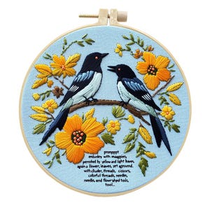 May include: Embroidered hoop art featuring two magpies perched on a branch, surrounded by yellow flowers and green leaves. The birds have black and white plumage. The text reads: "prompppt emburdery with maagpies..." The hoop is light blue.