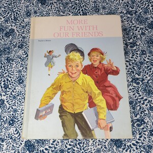 May include: A vintage book cover titled "MORE FUN WITH OUR FRIENDS" featuring illustrations of children. The cover art depicts a boy in a yellow jacket and a girl in a red coat, with a third child in the background. The book is a Teacher's Edition.