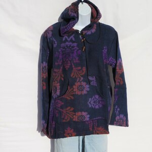 May include: A navy blue hooded sweatshirt with a floral pattern in shades of purple and orange. The sweatshirt has a drawstring hood and a kangaroo pocket.
