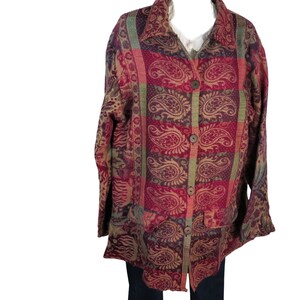 May include: A long-sleeved button-up shirt with a paisley pattern in shades of red, green, and brown.
