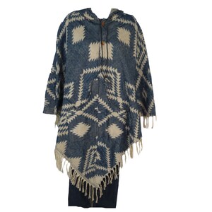 May include: A blue and white patterned hooded poncho with fringe trim. The poncho has a geometric design and a button closure.