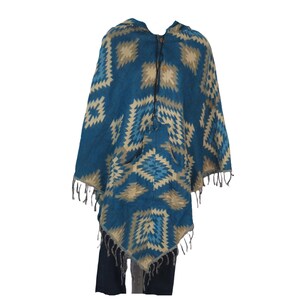 May include: A blue and beige hooded poncho with a geometric pattern and fringe trim. The poncho has a pocket on the front.