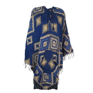 May include: A blue and beige hooded poncho with a geometric pattern and fringe trim. The poncho has a pocket on the front and a drawstring closure at the neck.