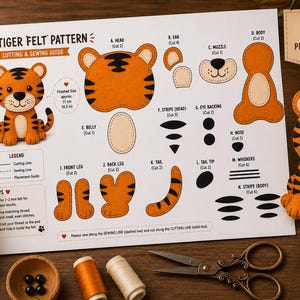 May include: A printed paper guide titled Tiger Felt Pattern featuring a cutting and sewing guide for a stuffed tiger toy. The sheet displays individual felt shapes labeled A through N, including head, body, and limb pieces, with a finished size of 4.3 inches.