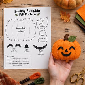 Pode incluir: Uma folha de molde de feltro Smiling Pumpkin medindo 21,6 por 27,9 cm, com modelos para corpo, folha, caule, olhos, nariz e boca. Ao lado, uma abóbora de feltro laranja medindo 10 por 8 cm com detalhes em feltro preto.