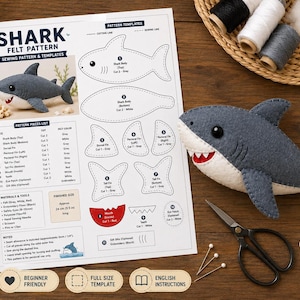 Puede incluir: Un patrón de costura de fieltro con forma de tiburón que incluye plantillas, instrucciones y un peluche de tiburón terminado en fieltro gris y blanco. El documento contiene etiquetas de texto para las piezas, materiales y notas adicionales.