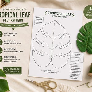 Pode incluir: Um molde de feltro para artesanato de uma folha tropical, incluindo um modelo de papel branco com contornos pretos, uma amostra de folha de feltro verde, um carretel de linha verde, uma agulha e tesouras douradas, com uma escala de 5 cm.