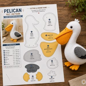 Puede incluir: Una guía de patrón de fieltro para pelícano con instrucciones impresas, formas numeradas para el cuerpo, cabeza, pico, alas y pies, y un pelícano terminado de fieltro blanco, amarillo y gris con un gran pico naranja y ojos negros.