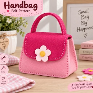 May include: A small felt handbag featuring a dark pink flap and a light pink body. The flap is decorated with a white flower applique with a yellow center. The bag has a single handle and white stitching along the edges. Two additional felt flowers are placed nearby.