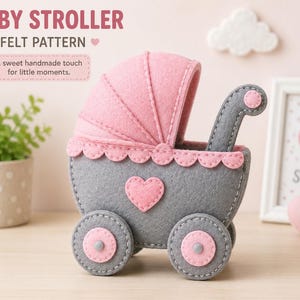 May include: A felt baby stroller craft featuring a grey body with a pink scalloped trim, a pink hood, and a pink heart applique. The wheels are grey with pink centres. Text reads: BABY STROLLER FELT PATTERN A sweet handmade touch for little moments.