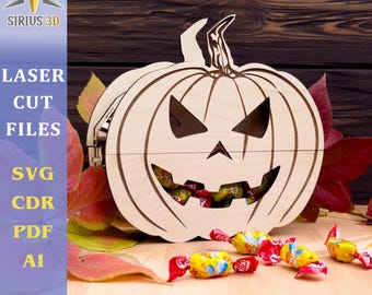 May include: A wooden pumpkin shaped box with a carved jack-o'-lantern face. The box is filled with colorful candies. The box is sitting on a wooden surface with fall leaves.