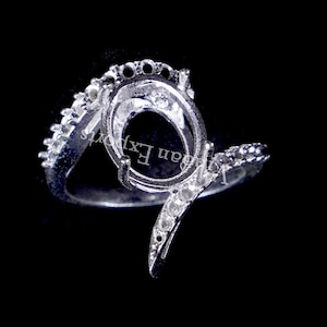 May include: Silver ring setting with a pave-set oval shaped bezel. The ring is designed with a twisted band.