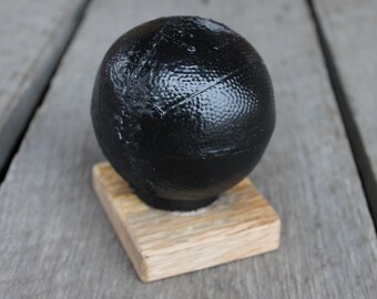 Handcrafted Basketball Made from Coal in Kentucky on a wood base