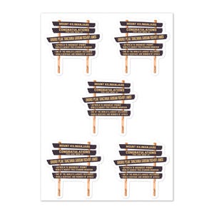 May include: A sheet of five identical stickers featuring a brown wooden signpost design. The text reads: MOUNT KILIMANJARO, CONGRATULATIONS YOU ARE NOW AT UHURU PEAK TANZANIA 5895M/19341FT AMSL, AFRICA'S HIGHEST POINT, WORLD'S HIGHEST FREE-STANDING MOUNTAIN.