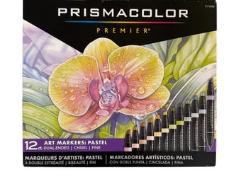 May include: A box of Prismacolor Premier art markers in pastel colors. The box features a watercolor painting of a yellow and pink orchid. The box contains 12 dual-ended markers with chisel and fine tips.