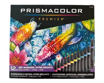 May include: Prismacolor Premier 12-count art markers set. The box features a colorful koi fish design. The markers are dual-ended with chisel and fine tips. The text on the box reads "ART MARKERS: HYPER BRIGHTS".