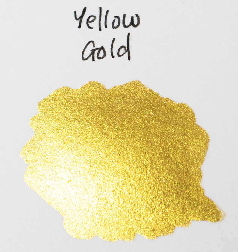 May include: A close-up of a gold ink sample with a shimmery finish. The ink is labeled "Yellow Gold".