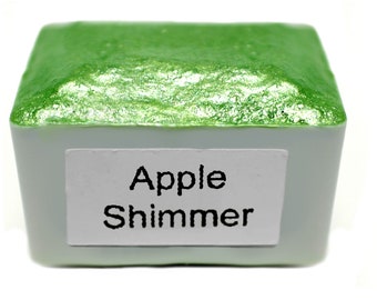 May include: A small square container of green watercolor paint with a label that reads "Apple Shimmer".