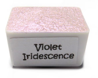 May include: A small, square container of violet iridescent paint. The container is white with a label that reads "Violet Iridescent".