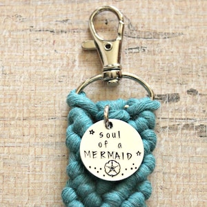 May include: Teal blue braided keychain with a silver charm that says "soul of a mermaid" with a starfish design.