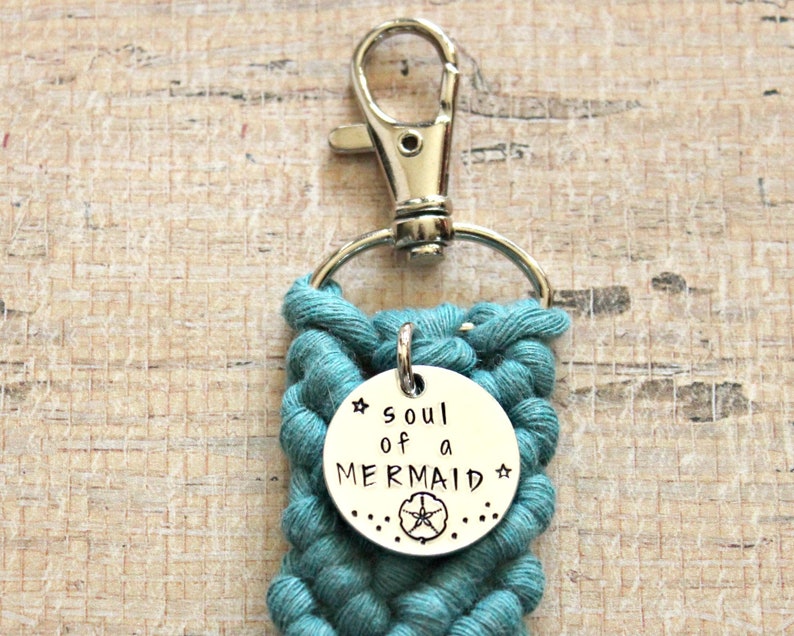 May include: Teal blue braided keychain with a silver charm that says "soul of a mermaid" with a starfish design.