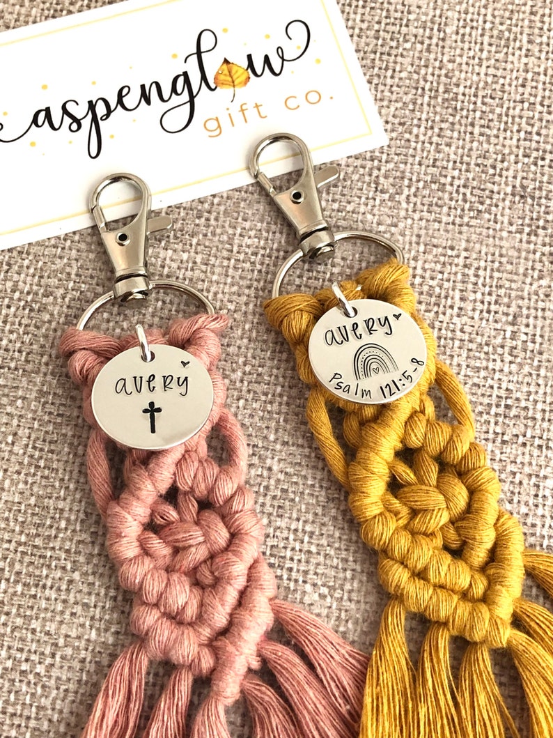 5" long macrame keychain with personalized discs featuring a cross or rainbow, name, and Bible verse.  These keychains come in a variety of colors and are fully customized