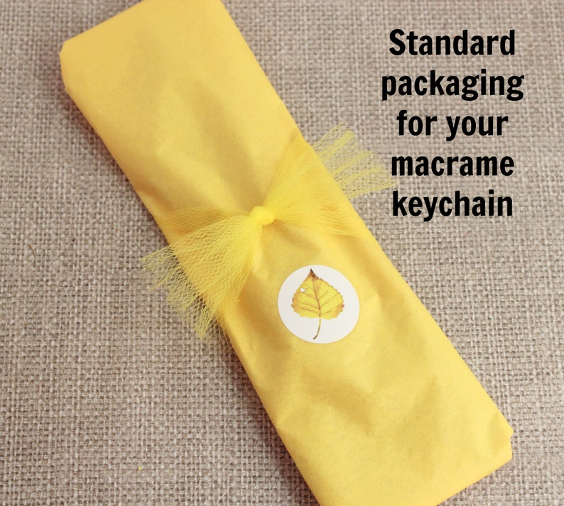 May include: A yellow macrame keychain wrapped in yellow tissue paper with a yellow tulle bow and a leaf sticker.  Standard packaging for your macrame keychain.