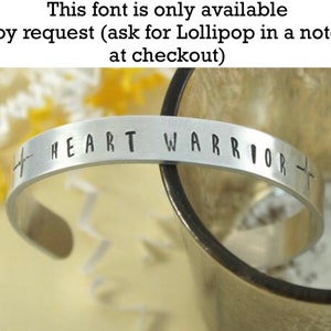 May include: Silver bracelet with the words "HEART WARRIOR" engraved on it. The font is available by request.