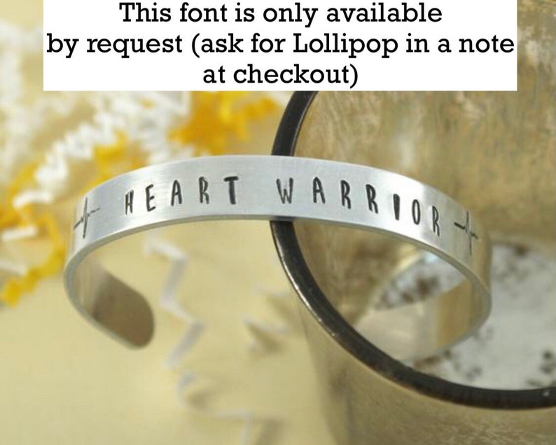 May include: Silver bracelet with the words "HEART WARRIOR" engraved on it. The font is available by request.