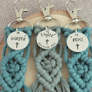 5" long macrame keychain with personalized discs featuring a cross, name, and Bible verse.  These keychains come in a variety of colors and are fully customized