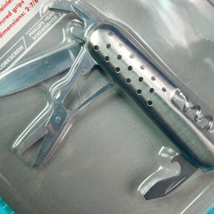 May include: A silver multi-tool with a corkscrew, scissors, and a Phillips head screwdriver. The tool is packaged in a clear plastic blister pack with the text "SCISSORS, CORKSCREW, PHILLIPS HEAD SCREWDRIVER" printed on the front.