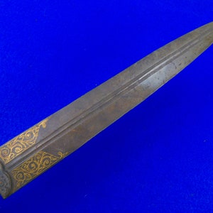 May include: A long, thin, silver-colored dagger with a gold-colored design on the blade. The dagger has a wooden handle.