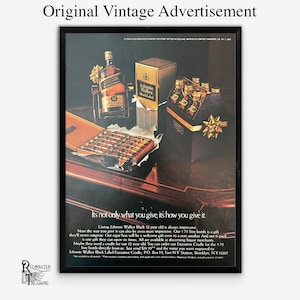 May include: Vintage advertisement for Johnnie Walker Black Label Scotch Whisky. The ad features a bottle of whiskey, a box of cigars, and a six-pack of whiskey. The text reads "It's not only what you give, it's how you give it."