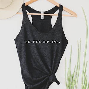 May include: Black tank top with the text "SELF DISCIPLINE" in white lettering with a small heart symbol.